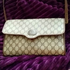 Gucci bag, over the shoulder strap.